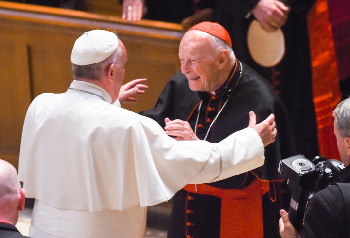 Pope Francis reaches out to hug Theodore McCarrick during a 2015 service in Washington, DC. McCarrick has since been def