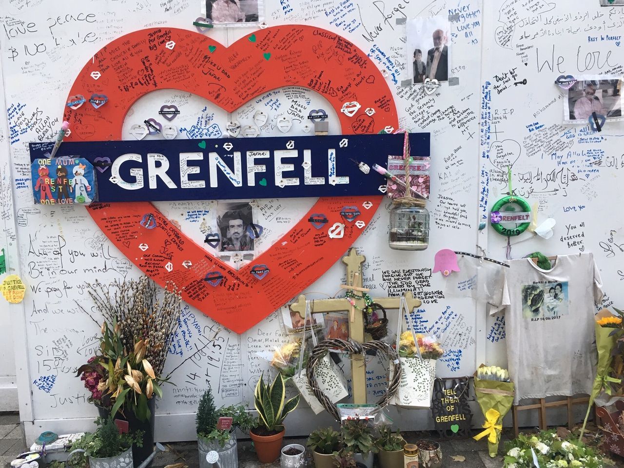 A memorial to the 72 people killed in the Grenfell fire on the hoardings surrounding the tower block