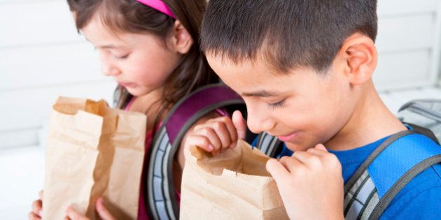 Siblings 6/7 digging in their school lunch bag