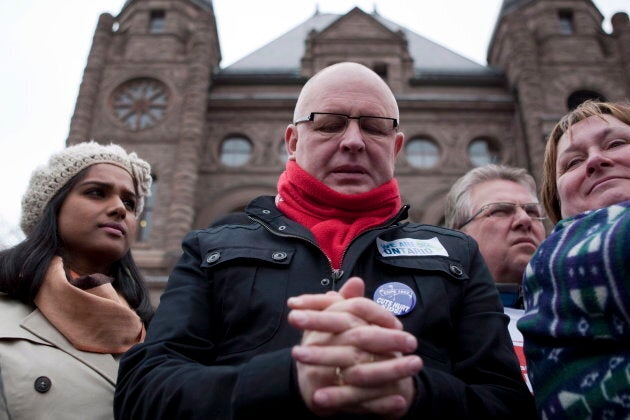 Sid Ryan of the Ontario Federation of Labour pauses before speaking to protesters gathered outside the Ontario Legislature in Toronto on April 21, 2012.