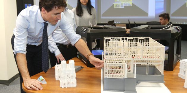 Prime Minister Justin Trudeau looks at construction models created by 3D printers at the George Brown College Casa Loma campus in Toronto, March 23, 2017.