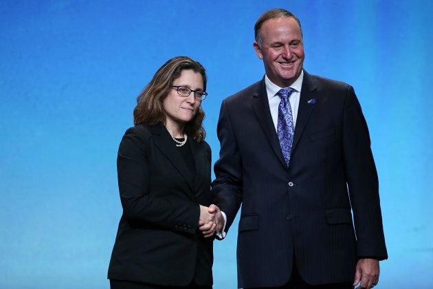 Canada's Minister of International Trade Chrystia Freeland, left, with New Zealand Prime Minister John Key, right, after signing the Trans Pacific Partnership at Sky City on Feb. 4, 2016 in Auckland, New Zealand.