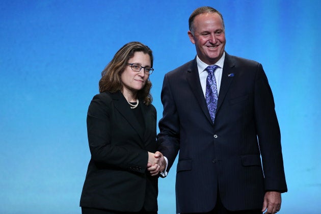 Canada's Minister of International Trade Chrystia Freeland, left, with New Zealand Prime Minister John Key, right, after signing the Trans Pacific Partnership at Sky City on Feb. 4, 2016 in Auckland, New Zealand.