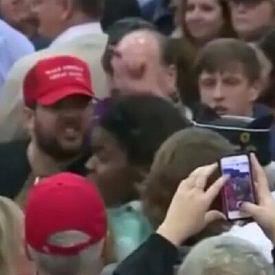 Matthew Heimbach, the bearded man in the MAGA cap, shoves an African American protester at a Trump rally in Louisville, Kentucky, in 2016. Heimbach later pleaded guilty to disorderly conduct.
