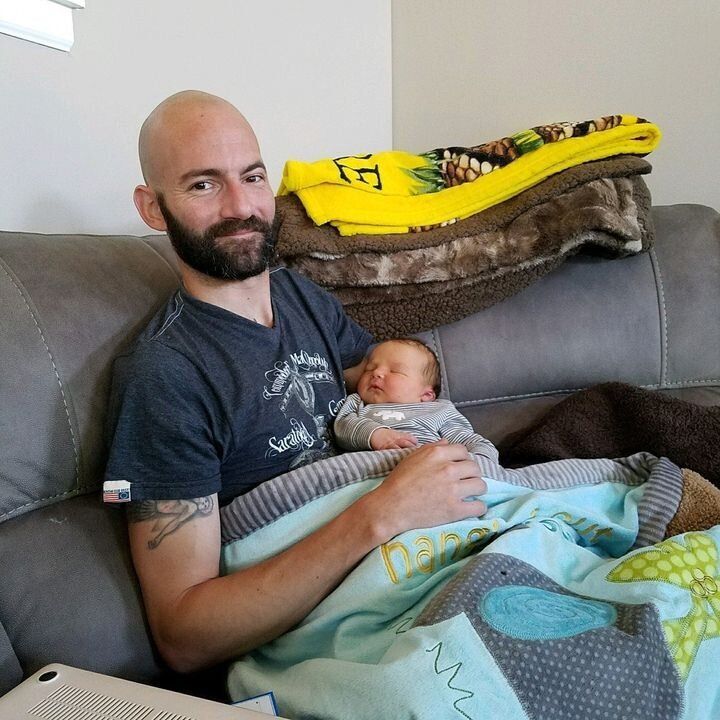 Derek Rotondo with his newborn son Lincoln in 2017.