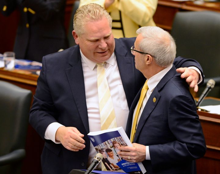 Ontario Finance Minister Vic Fedeli is congratulated by Premier Doug Ford after introducing the budget at the legislature in Toronto on April 11, 2019.