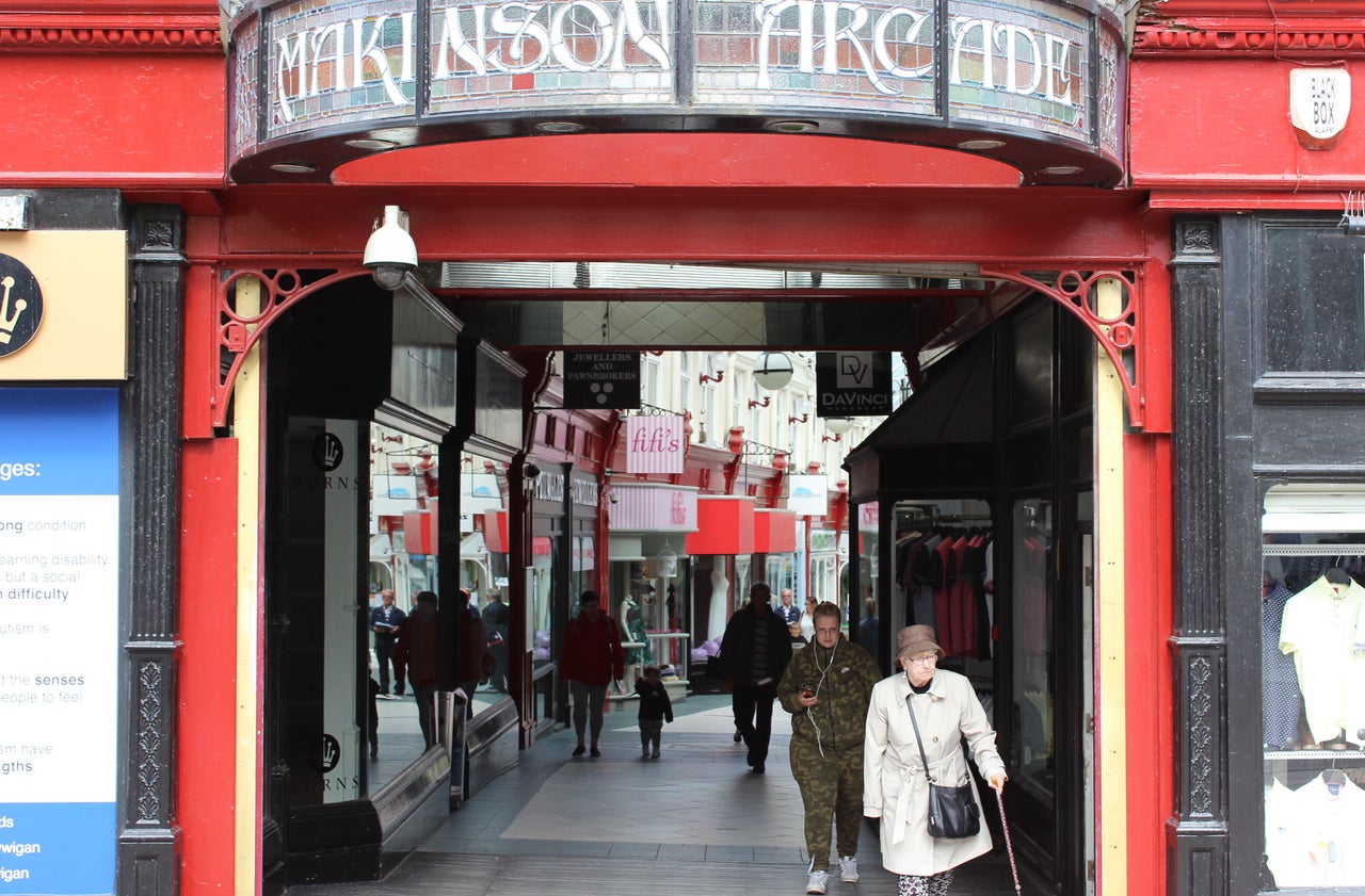 Wigan's town centre appears cut in half, contrasted between a hulking new shopping centre, and its older arcades and markets.