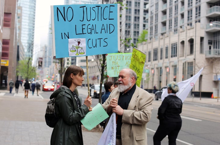 Dana Fisher, a legal aid union representative, outside of the Ministry of Attorney General's office in May protesting the cuts to legal aid. She was joined by other Society of United Professionals members, including President Scott Travers (right).