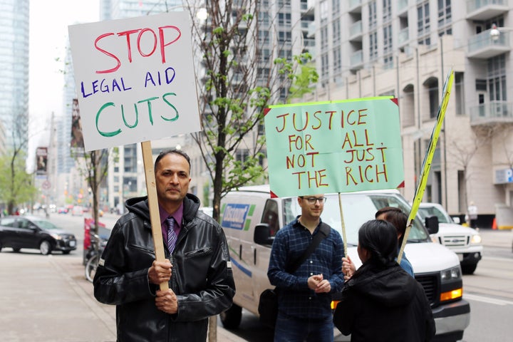 Protesters outside the Ministry of Attorney General's office in Toronto took a stand against the cuts to legal aid, saying they're unjust.