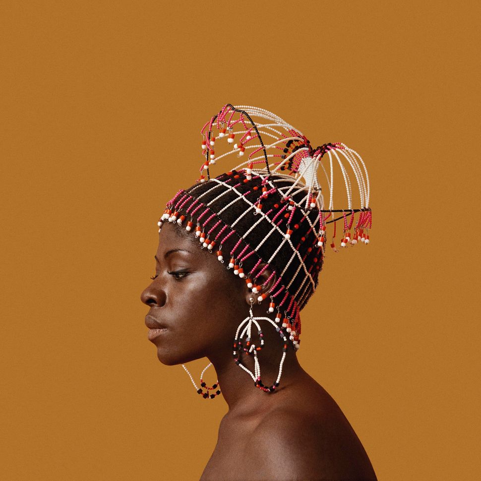 Sikolo Brathwaite wearing a headpiece designed by Carolee Prince, African Jazz-Art Society &amp; Studios (AJASS), Harlem, circa 1968. From "Kwame Brathwaite: Black Is Beautiful" (Aperture, 2019).