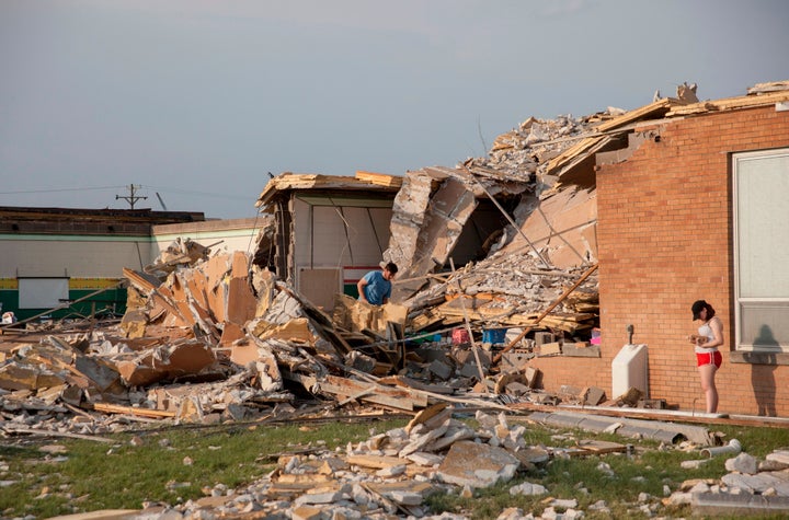 Damage at a school in Dayton, Ohio, is surveyed on Tuesday, after powerful tornadoes ripped through the area and caused at least one death.