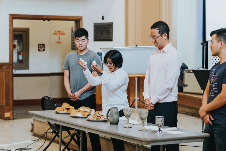 Pastor Eula Pagdilao of the First Progressive Church in Los Angeles blesses bread during a service at the PAAC conference.