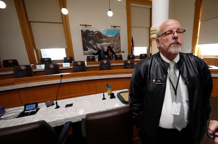 Wearing his son's leather jacket, Colorado Rep. Tom Sullivan waits to speak during a hearing before the House Judiciary Committee on a bill to get a "red flag" gun law on the books in Colorado Thursday, Feb. 21, 2019, in Denver.