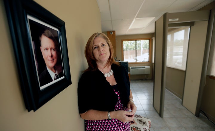 In this photo taken Friday, Aug. 23, 2013, South Wind Women’s Center executive director Julie Burkhart stands in the entryway of her clinic which was once owned by slain Dr. George Tiller.