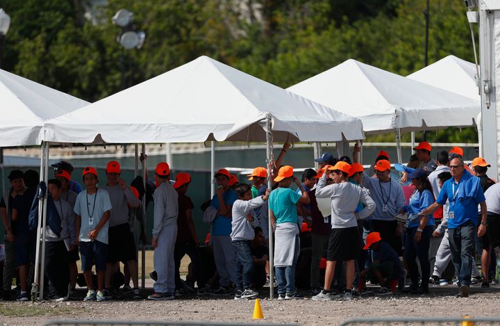 Migrant children stand outside the Homestead Temporary Shelter for Unaccompanied Children in Homestead, Florida, on May 6, 2019.