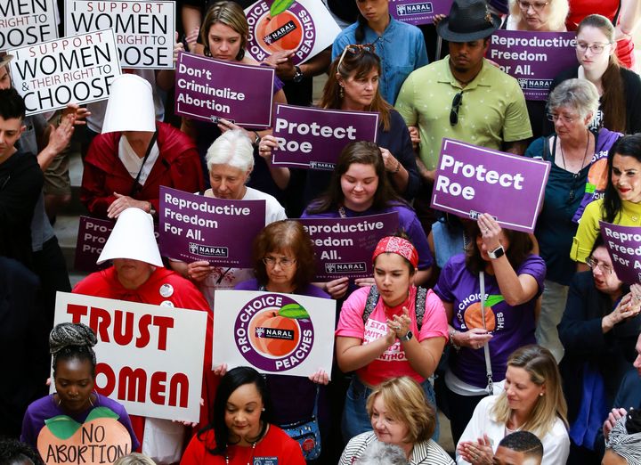 Activists and politicians in Atlanta protest Georgia's strict anti-abortion law that was signed by the governor last month.