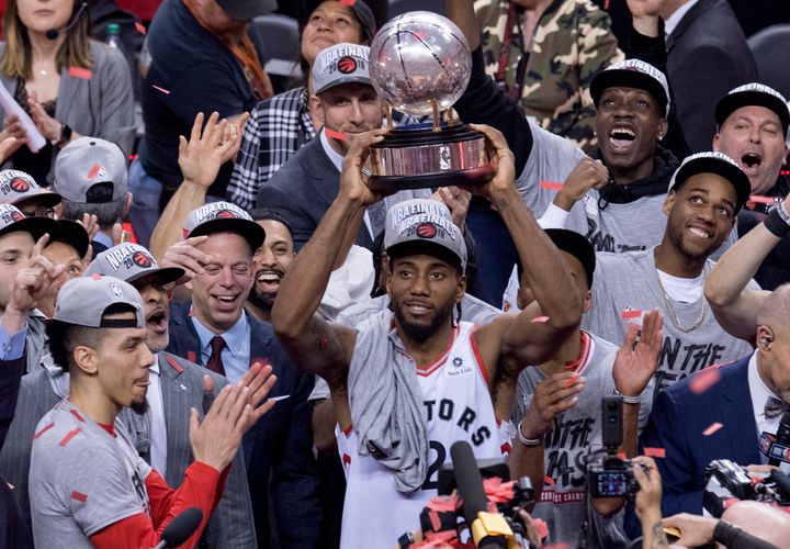 Kawhi Leonard holds up a trophy after the Toronto Raptors win the Eastern Conference finals.