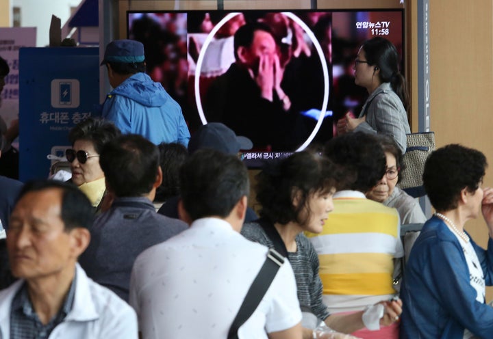 People watch a TV screen showing an image of senior North Korean official Kim Yong Chol in a musical performance by the wives of Korean People's Army officers in North Korea during a news program at the Seoul Railway Station in Seoul, South Korea. (AP Photo/Ahn Young-joon)