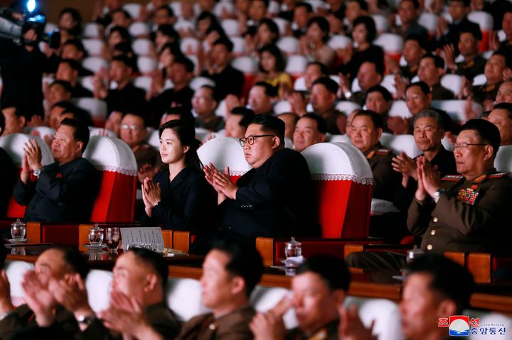 In this June 2, 2019, photo provided on Monday, June 3, 2019, by the North Korean government, North Korean leader Kim Jong Un, center right, and his wife Ri Sol Ju, center left, clap hands in a musical performance by the wives of Korean People's Army officers in North Korea.