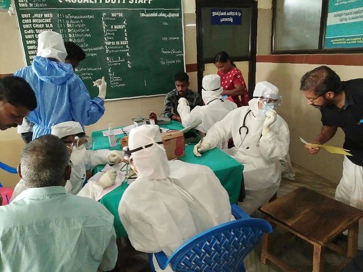 Medical personnel wearing protective suits check patients at the Medical College hospital in Kozhikode on 21 May 2018. 