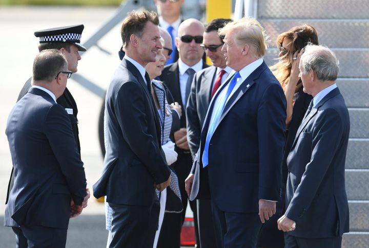 President Donald Trump talks to Foreign Secretary Jeremy Hunt at London's Stansted Airport on Monday morning.