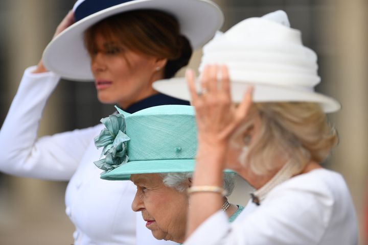 Blustery conditions saw Melania Trump and Camilla, Duchess of Cornwall, hold onto their hats. Camilla wore a white Anna Valentine dress and a Philip Treacy hat.