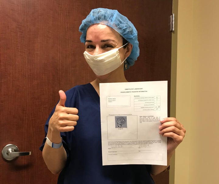 My gestational carrier took this picture of me ecstatically holding an image of the male embryo before the transfer.