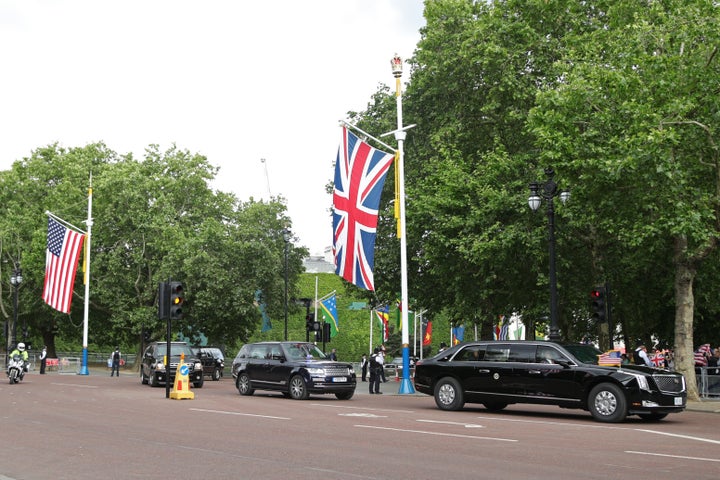 Only a handful of American flags can be seen as Trump drives down the Mall.