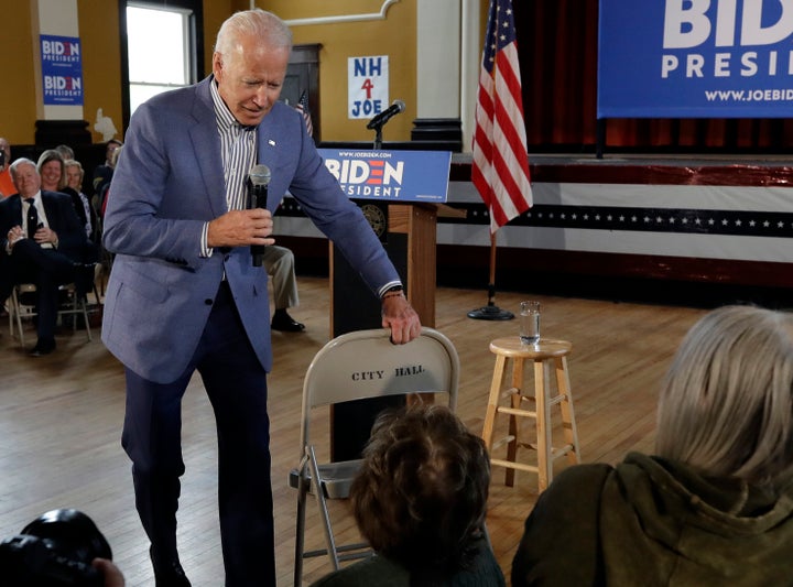 Former vice president and Democratic presidential candidate Joe Biden brings a chair over for a woman in the audience during a campaign event on Tuesday in Berlin, New Hampshire.