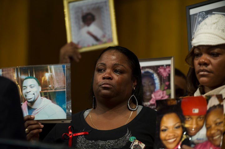 Antionette Johnson, of Oakland, California, holds a photo of her son Terrell Reams, 23, who was shot and killed in Oakland, at a 2013 meeting of groups working to prevent gun violence.