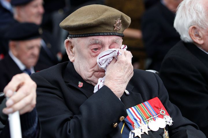 A veteran wipes his eyes during the ceremony.