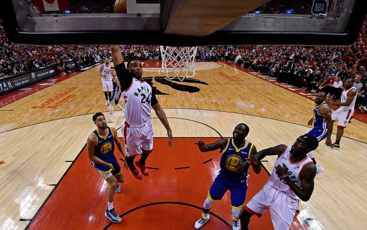 Toronto Raptors forward Norman Powell (24) shoots the ball against Golden State Warriors forward Draymond Green (23) in game two of the 2019 NBA Finals in Toronto, June 2, 2019.