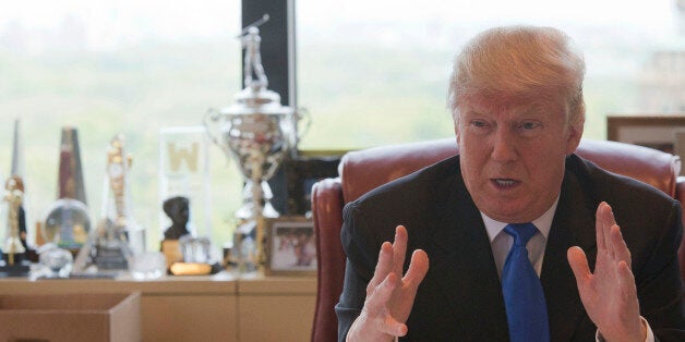 Republican presidential candidate Donald Trump gestures as he speaks during an interview with The Associated Press in his off