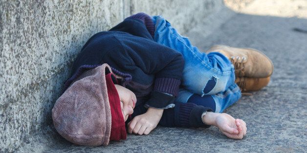 young homeless boy sleeping on the bridge, poverty, city, street