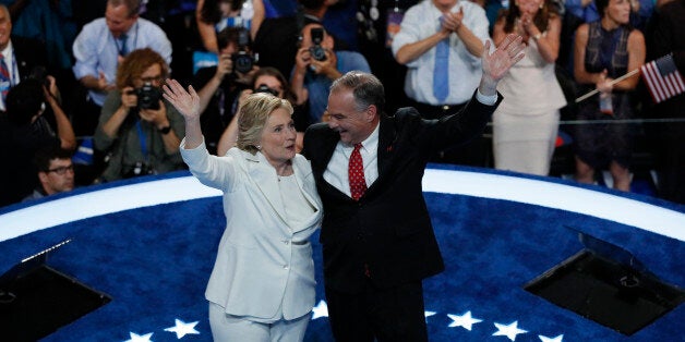 Democratic presidential nominee Hillary Clinton waves with her vice presidential running mate Senator Tim Kaine after accepti