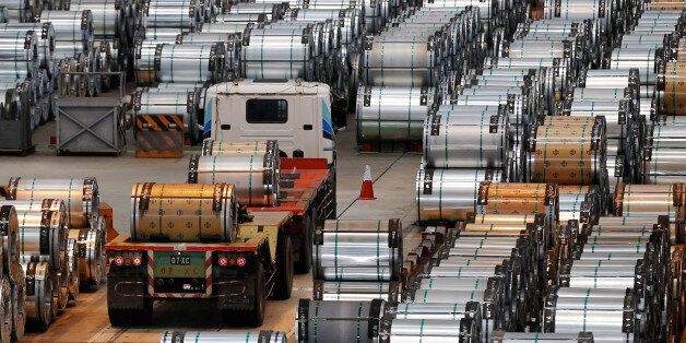 A truck drives past rolls of steel inside the China Steel Corporation factory, in Kaohsiung, southern Taiwan August 26, 2016. REUTERS/Tyrone Siu
