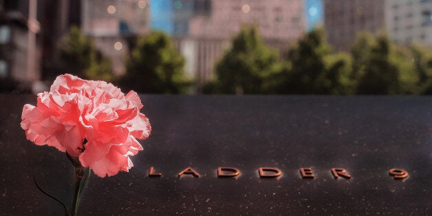 United States of America, New York City, Lower Manhattan, Groun Zero , September 11 Memorial.A view of a rose placed at the September 11 memorial in the Ground Zero of NY.The inscription is dedicated to the fire fighters died there.