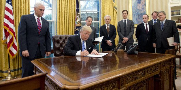 U.S. Donald Trump signs an executive order withdrawing the U.S. from the Trans-Pacific Partnership (TPP) in the Oval Office of the White House in Washington, D.C., U.S., on Monday, Jan. 23, 2017. Trump abruptly ended the decades-old U.S. tilt toward free trade by signing an executive order to withdraw from an Asia-Pacific accord that was never ratified and promising to renegotiate the North American Free Trade Agreement. Photographer: Ron Sachs/Pool via Bloomberg