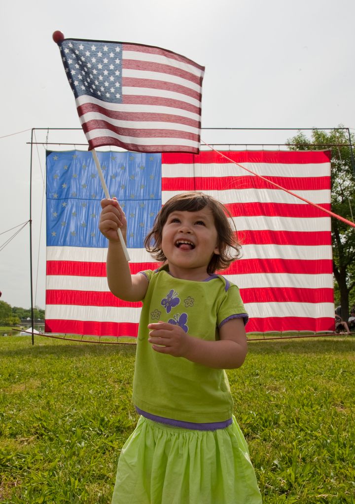 Girl waves an american flag on Memorial Day