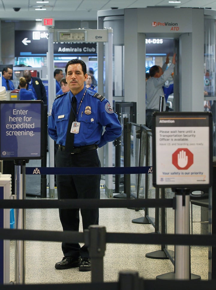 MIAMI, FL - OCTOBER 04: A TSA agent waits for passengers to use the TSA PreCheck lane being implemented by the Transportation Security Administration at Miami International Airport on October 4, 2011 in Miami, Florida. The pilot program launched today for fliers to use the expedited security screening in Miami, Atlanta, Detroit and Dallas/Fort Worth.The lane has a metal detector rather than a full-body imaging machine and passengers will no longer no need to remove shoes, belts, light outerwear, and bags of liquids that are compliant with TSA restrictions. (Photo by Joe Raedle/Getty Images)