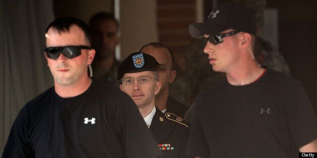 FORT MEADE, MD - JUNE 03: U.S. Army Private First Class Bradley Manning (C) is escorted as he leaves a military court for the day June 3, 2013 at Fort Meade in Maryland. Manning was due to face court martial for allegedly sending hundreds of thousands of government documents to Wikileaks for aiding the enemy. (Photo by Alex Wong/Getty Images)