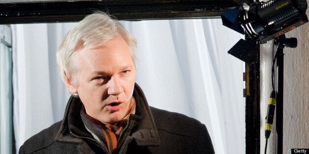 Wikileaks founder Julian Assange addresses members of the media and supporters from the window of the Ecuadorian embassy in Knightsbridge, west London on December 20, 2012. WikiLeaks will release one million documents next year affecting every country in the world, founder Julian Assange said in a speech from the balcony of the Ecuadorian embassy in London. In a 'Christmas message' marking six months since he sought asylum in the embassy to avoid extradition to Sweden over claims of rape and sexual assault, Assange also said the door was open to negotiations. AFP PHOTO/Leon Neal (Photo credit should read LEON NEAL/AFP/Getty Images)