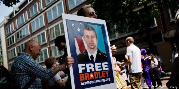 LONDON, UNITED KINGDOM - JUNE 29: A man participating in the LGBT parade carries a placard about imprisoned US military whistleblower, Bradley Manning, at the annual London Pride Parade, on June 29, 2013, in London, Untied Kingdom. The Pride Parade originated in 1971, with this years theme being Love (and marriage), due the increased social and political pressure to make gay marriage law in the UK and several other countries throughout the world. (Photo by Warrick Page/Getty Images)