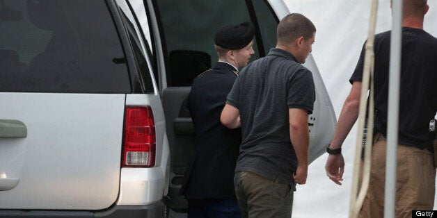 FORT MEADE, MD - JULY 25: U.S. Army Private First Class Bradley Manning is escorted by military police as he arrives for closing arguments in his military trial July 25, 2013 Fort George G. Meade, Maryland. Manning, who is charged with aiding the enemy and wrongfully causing intelligence to be published on the internet, is accused of sending hundreds of thousands of classified Iraq and Afghanistan war logs and more than 250,000 diplomatic cables to the website WikiLeaks while he was working as an intelligence analyst in Baghdad in 2009 and 2010. (Photo by Chip Somodevilla/Getty Images)