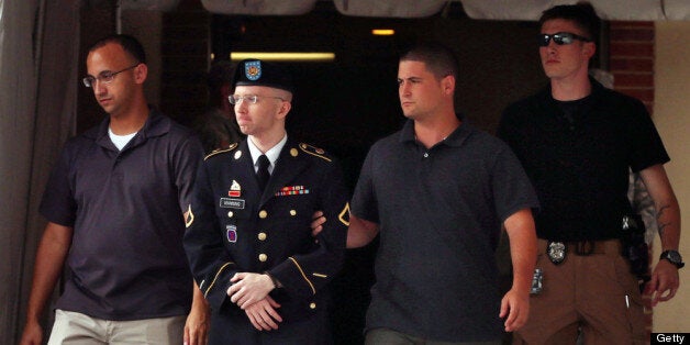 FORT MEADE, MD - JULY 25: U.S. Army Private First Class Bradley Manning (2nd L) is escorted by military police as he leaves after the first day of closing arguments in his military trial July 25, 2013 Fort George G. Meade, Maryland. Manning, who is charged with aiding the enemy and wrongfully causing intelligence to be published on the internet, is accused of sending hundreds of thousands of classified Iraq and Afghanistan war logs and more than 250,000 diplomatic cables to the website WikiLeaks while he was working as an intelligence analyst in Baghdad in 2009 and 2010. (Photo by Chip Somodevilla/Getty Images)