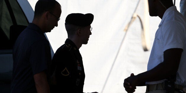 FORT MEADE, MD - AUGUST 14: U.S. Army Private First Class Bradley Manning (C) arrives at a military court facility for the sentencing phase of his trial August 14, 2013 in Fort Meade, Maryland. Manning was found guilty of several counts under the Espionage Act, but acquitted of the most serious charge of aiding the enemy. (Photo by Mark Wilson/Getty Images)