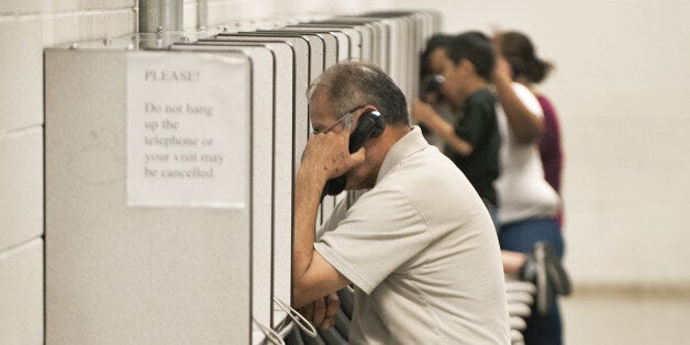 Visitors use a video phone to communicate during visiting hours with a friend or relative incarsarated inside Sheriff Joe Arpaio's Maricopa County 'tent city' jail May 3, 2010, in Phoenix, Arizona. This area of the tent city houses misdemeanor offenders. In August, 1993, Arpaio started the nation?s largest Tent City for convicted inmates. Two thousand convicted men and women serve their sentences in a canvas incarceration compound. AFP Photo/Paul J. Richards (Photo credit should read PAUL J. RICHARDS/AFP/Getty Images)