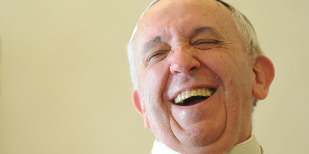 Pope Francis laughs during a private audience with the Prime Minister of Saint Vincent and the Grenadines at the Vatican on December 19, 2013. AFP PHOTO POOL / TIZIANA FABI (Photo credit should read TIZIANA FABI/AFP/Getty Images)