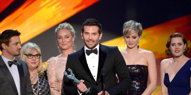 LOS ANGELES, CA - JANUARY 18: (L-R) Actors Jeremy Renner, Elisabeth Rohm, Bradley Cooper, Jennifer Lawrence and Amy Adams accept the Outstanding Performance by a Cast in a Motion Picture award for 'American Hustle' onstage during the 20th Annual Screen Actors Guild Awards at The Shrine Auditorium on January 18, 2014 in Los Angeles, California. (Photo by Kevork Djansezian/Getty Images)