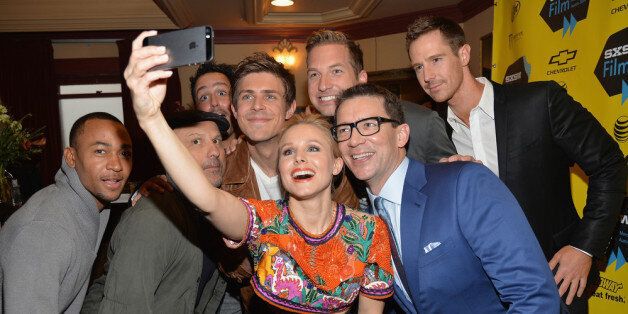 AUSTIN, TX - MARCH 08: Actress Kristen Bell (C) poses for a selfie with cast members (L-R) Percy Daggs, Enrico Colantoni, Chris Lowell, Ryan Hansen, Jason Dohring and director Rob Thomas at the premiere of 'Veronica Mars' during the 2014 SXSW Music, Film + Interactive Festival at the Paramount Theatre on March 8, 2014 in Austin, Texas. (Photo by Michael Buckner/Getty Images for SXSW)